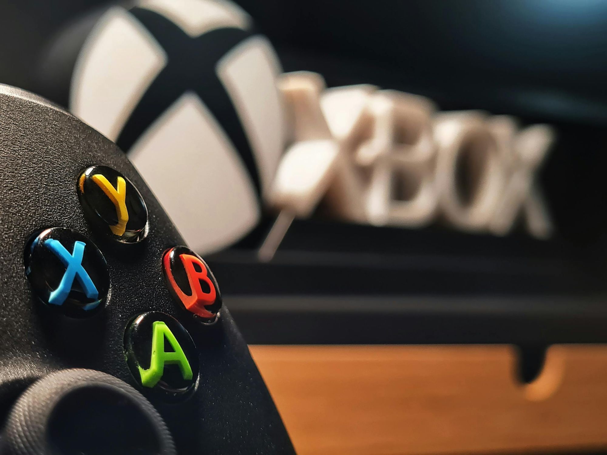 Xbox gaming controller in front Xbox logo