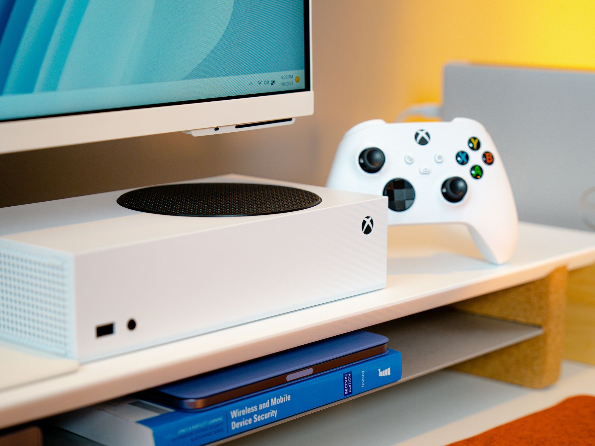 xbox series s console pictured on a shelf in an office
