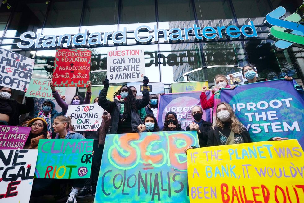 Young activists take part in the Youth Strike to Defund Climate Chaos protest against the funding of fossil fuels outside Standard Chartered Bank in London.