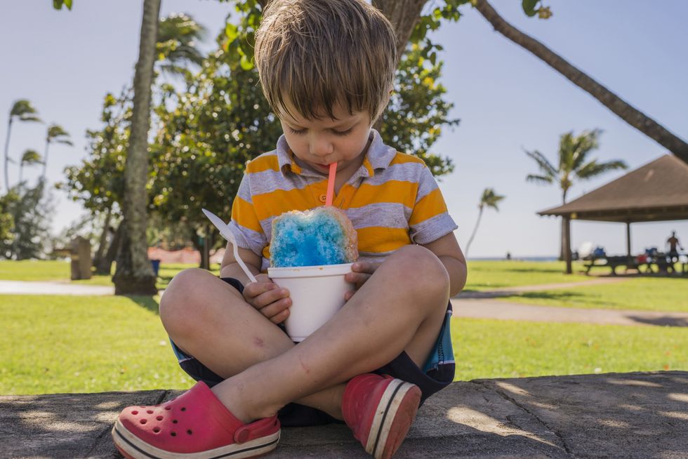 Young boy drinking slushie