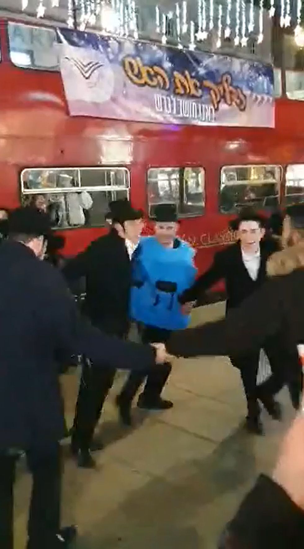 Young Jewish people during an open-top party bus in Oxford Street. The group was spat at by a group of men in a \%22bigoted antisemitic attack\%22.