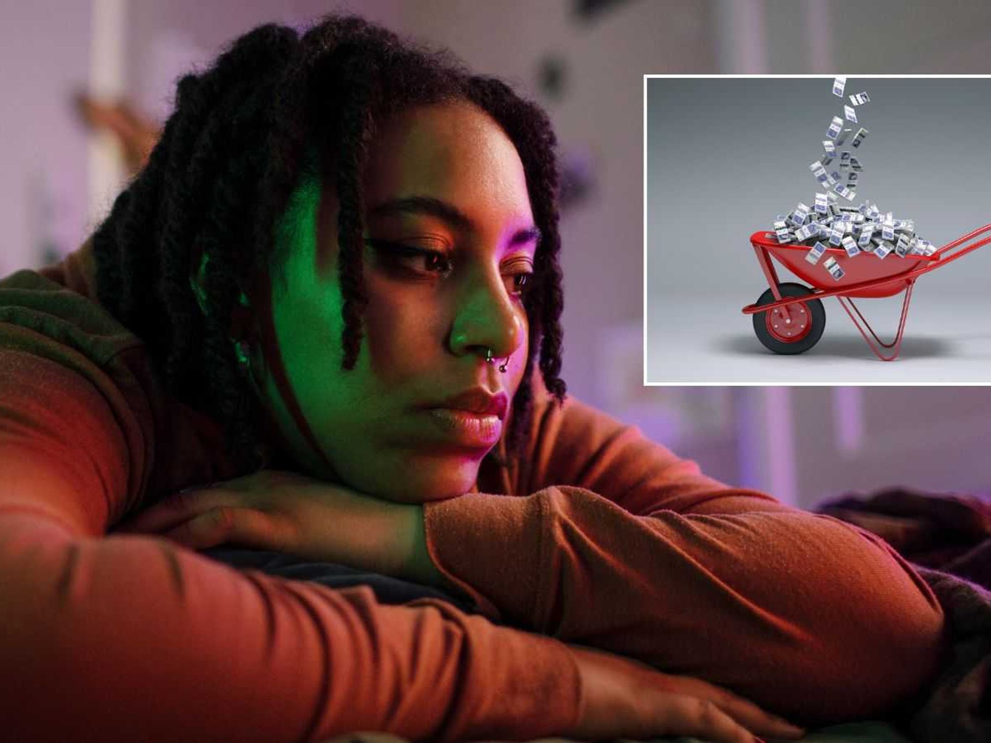 Young person looking sad and cash wheel-barrow