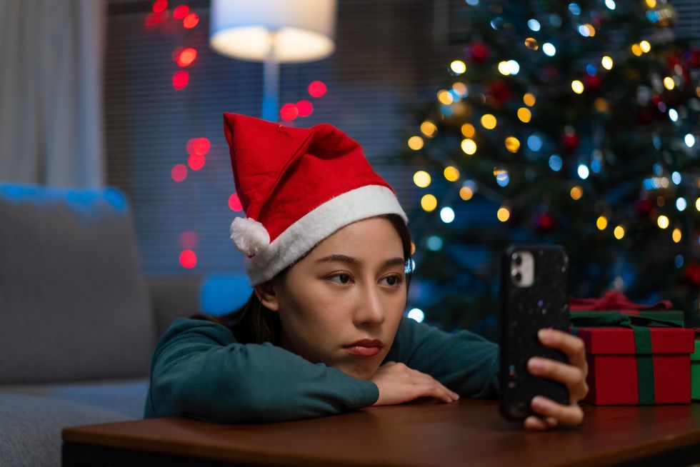 Young woman looking bored at Christmas