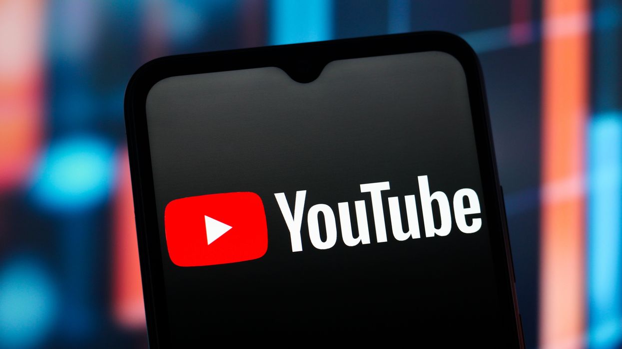 YouTube logo on smartphone with colourful background