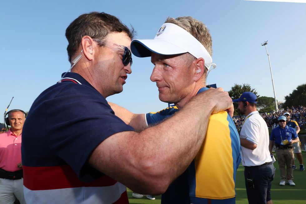 Zach Johnson, Captain of Team United States interacts with Luke Donald, Captain of Team Europe on the 18th green