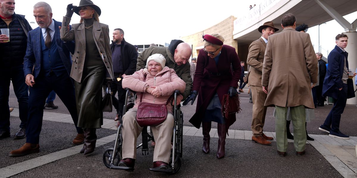 Zara Tindall helps racegoer at Cheltenham with their wheelchair Zara Tindall helps racegoer at Cheltenham with their wheelchair