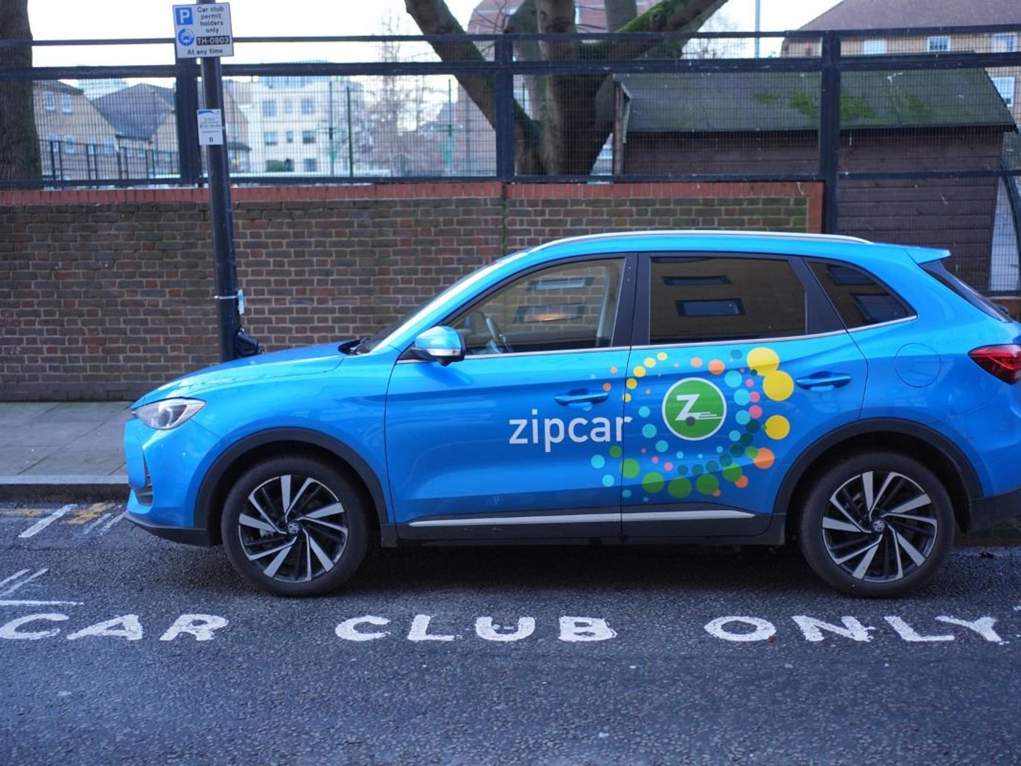 Zipcar electric vehicle parked in a car club parking space