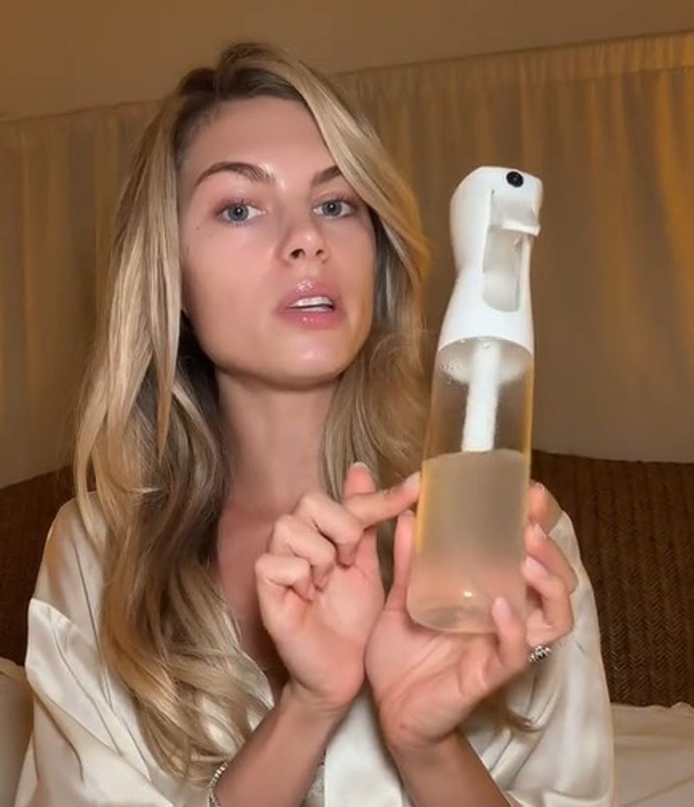 Zo\u00e9 holding her hair spray