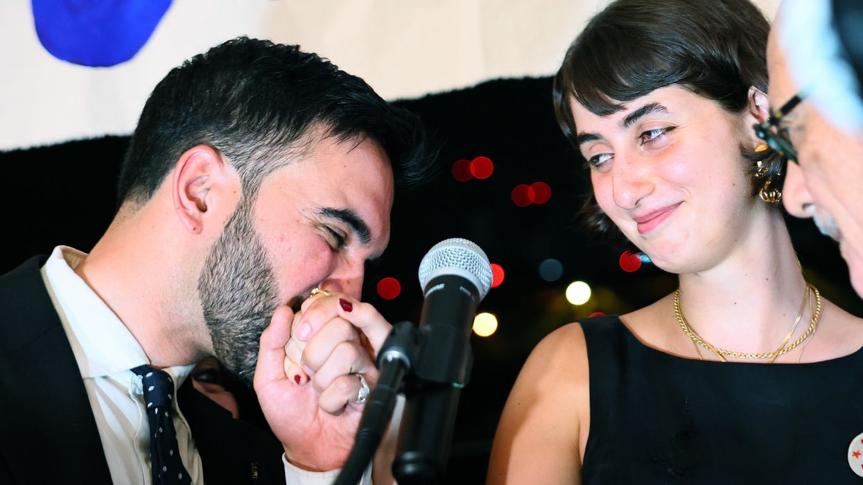Zohran Mamdani kisses the hand of his wife Rama Duwaji as they celebrate during an election night gathering